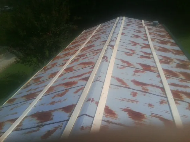 Rusted metal roof panels with new wood purlins before replacement — Storm Damage Roof Repair in Kiowa by Roofing Brothers